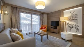 A modern living room with a sofa, coffee table, and a television.