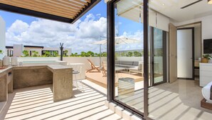 A modern outdoor living area with a pool, seating, and a view of the landscape. - Beautifully Minimalistic Studio Wrapped in Nature by Stella Rentals (Tulum)