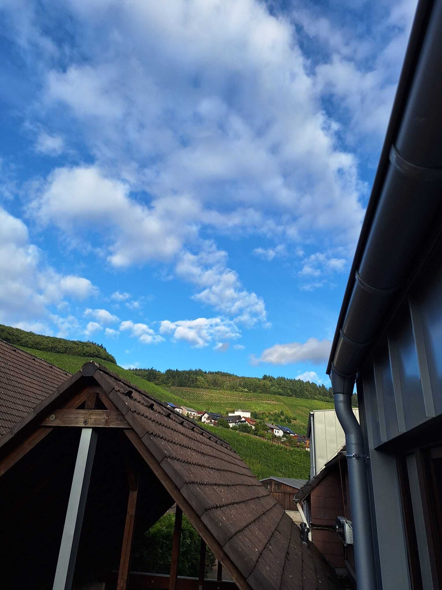 A rural village with traditional houses and a clear blue sky.