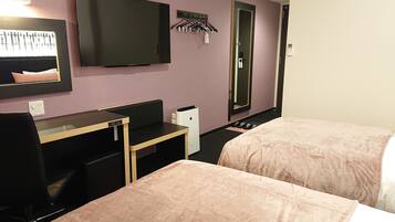 A hotel room with two beds, a desk, a chair, a TV, a mirror, and a coat rack.