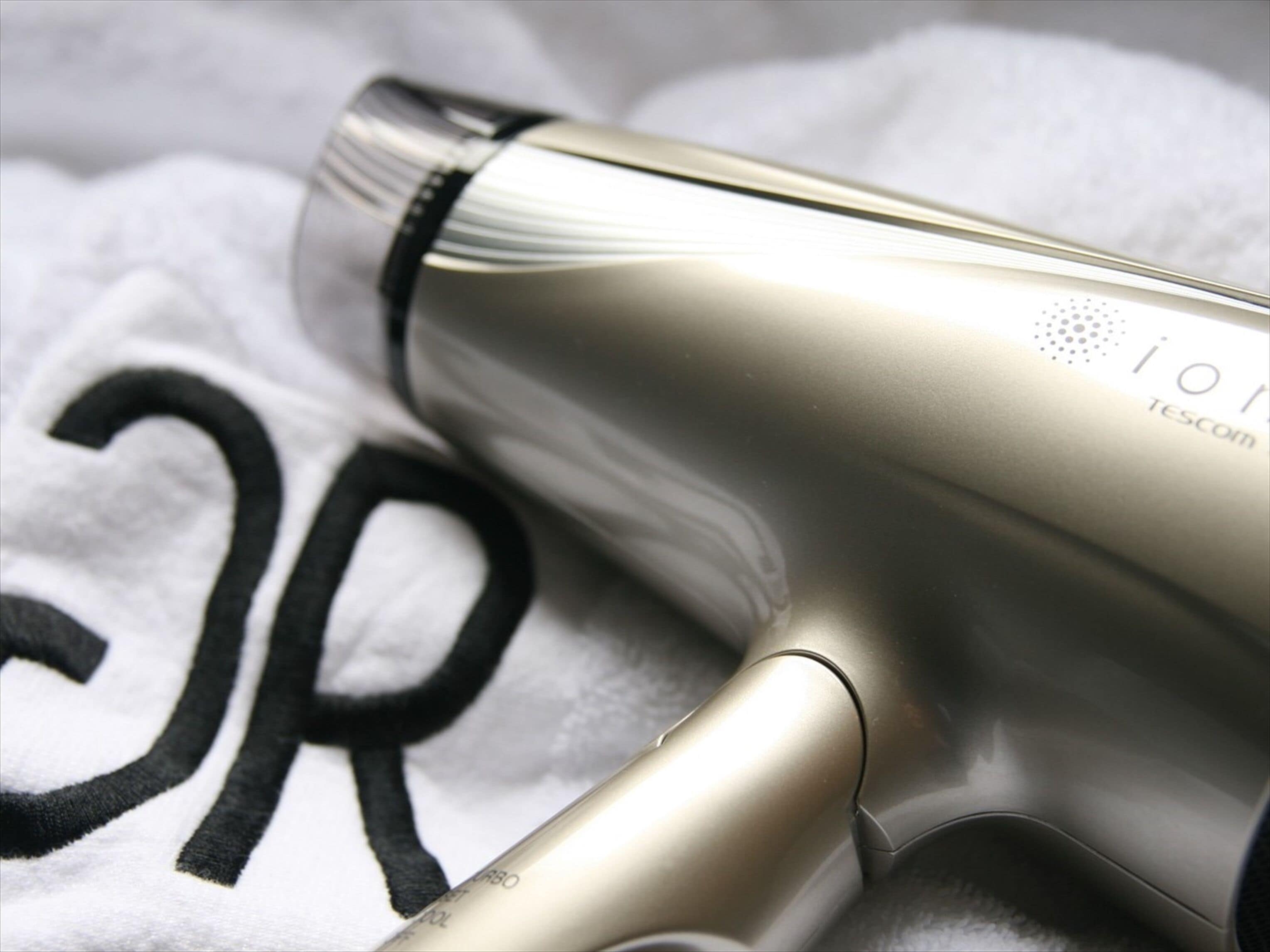 A hairdryer with a metallic finish and a visible brand logo.