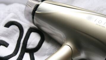 A hairdryer with a metallic finish and a visible brand logo.