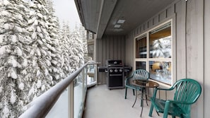 Enjoy al fresco dining and cooking on the balcony, which features a grill and a small table.