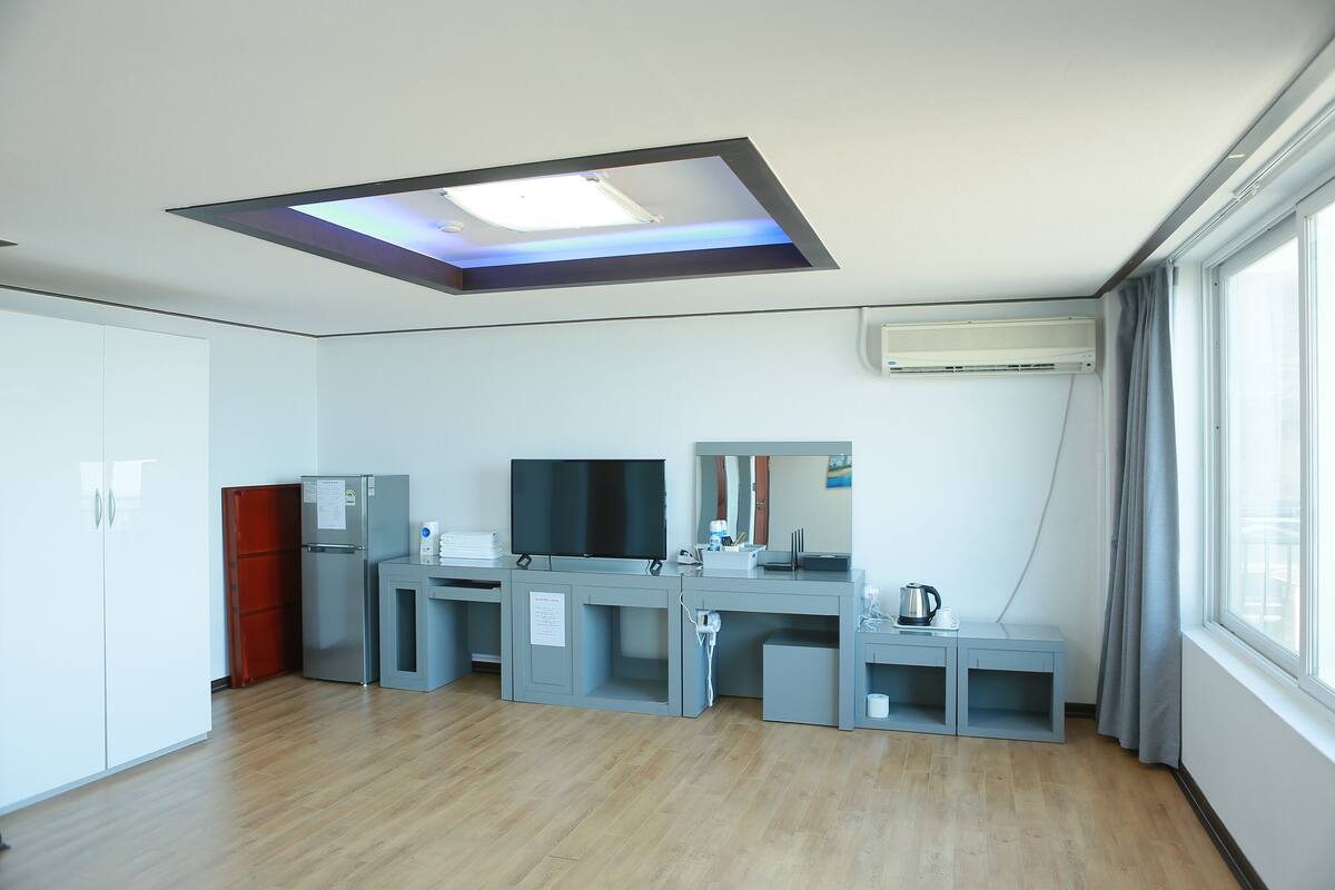 A modern kitchen with a built-in TV, a microwave, and a coffee maker.