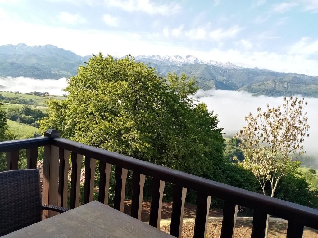 A deck with a view of a lake and mountains.