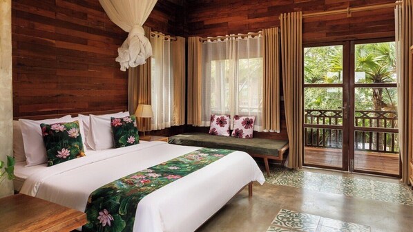 A wooden room with a bed, bench, and curtains. - Dontrei Villa Angkor (Siem Reap)
