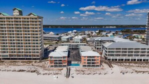 A beachfront hotel with multiple buildings, a swimming pool, and a beach area. - Harbor House B6 2 Bedroom Condo by RedAwning (Gulf Shores)