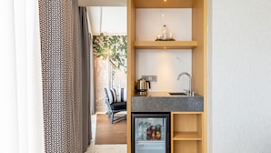 A compact kitchen with a built-in refrigerator, a coffee machine, and a sink. - Stayso The House Hotel (Istanbul)
