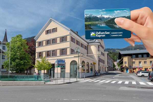 A building with a sign for 'Zell am See' and 'Kaprun' summer card.