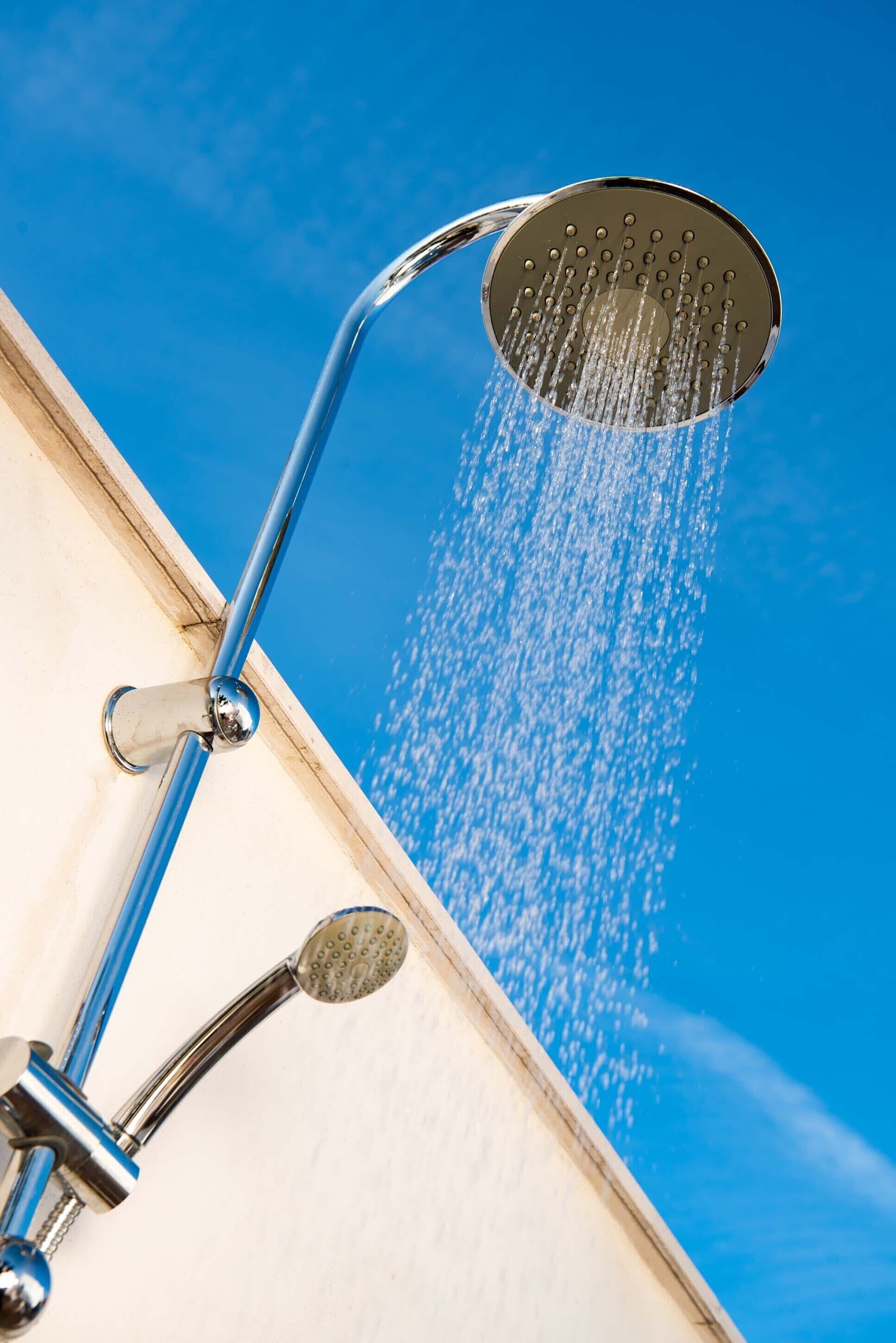 A showerhead with water flowing from it.