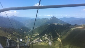 A cable car system with a mountainous landscape in the background.
