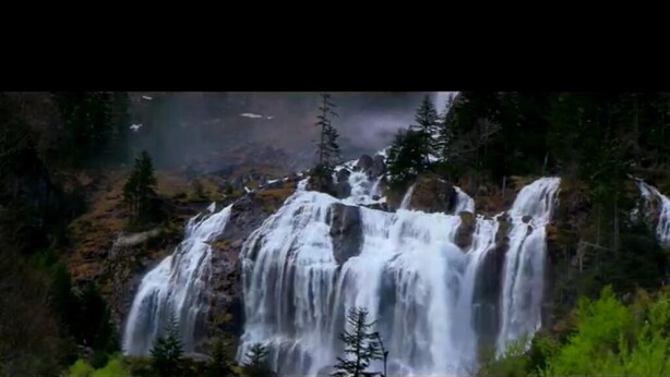 A waterfall surrounded by trees.