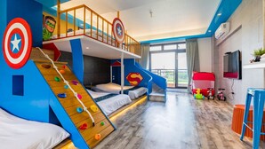 A child's bedroom with bunk beds, a climbing wall, and superhero-themed decorations. - Yanduo Homestay (Luodong)