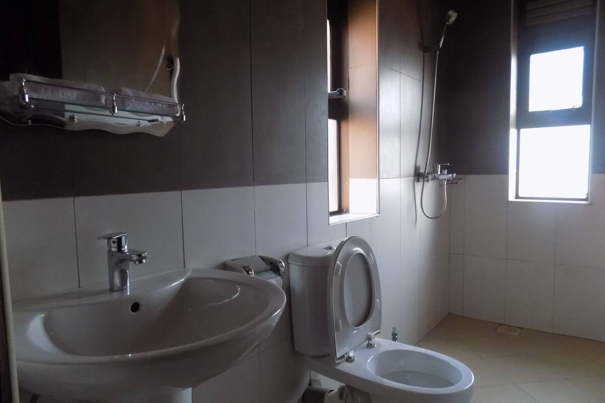 A bathroom with a sink, toilet, and shower.