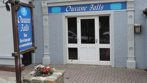 A building with a sign reading "Ouvane Falls Bar Restaurant Accommodation".