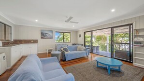 A spacious living area with a sofa, coffee table, and a balcony with a view. - Seascape - 154 Camden Head Rd Dunbogan (Dunbogan)