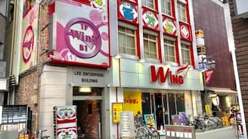 A Wing restaurant with a prominent sign, a storefront, and bicycles parked outside.
