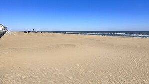 A wide, sandy beach with a clear blue sky. - Spacious Beach Retreat Near VB Boardwalk! (Virginia Beach)