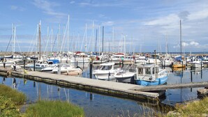 A marina with numerous boats docked at the pier.
