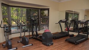 A gym with various exercise equipment, including treadmills, elliptical machines, and stationary bikes. - Royal Paragon Hotel (Port Harcourt)