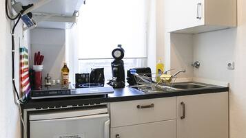 Apartment | Private kitchen | Fridge, microwave, stovetop, cookware/dishes/utensils