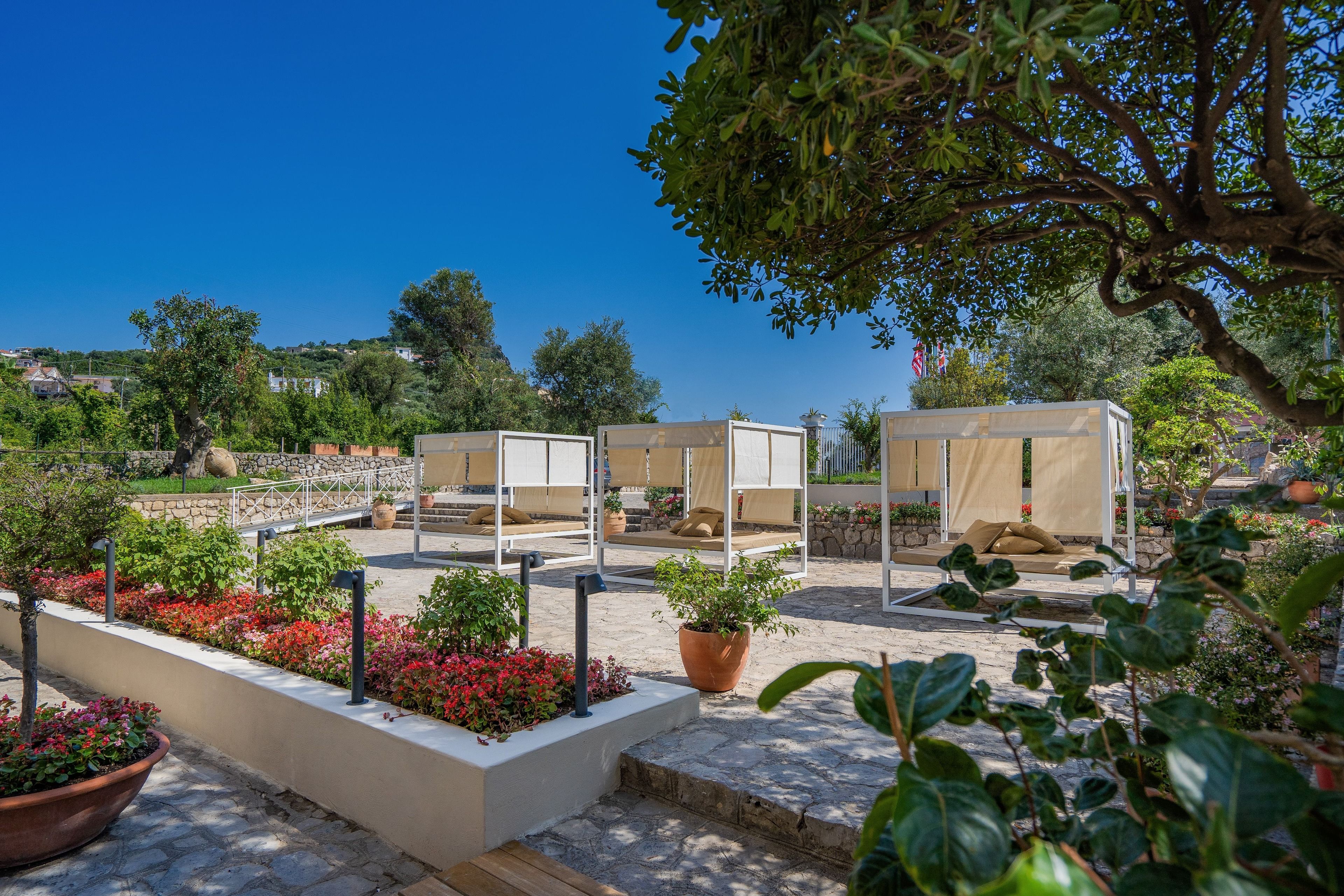 A patio area with outdoor seating, planters, and a view of the surrounding landscape.
