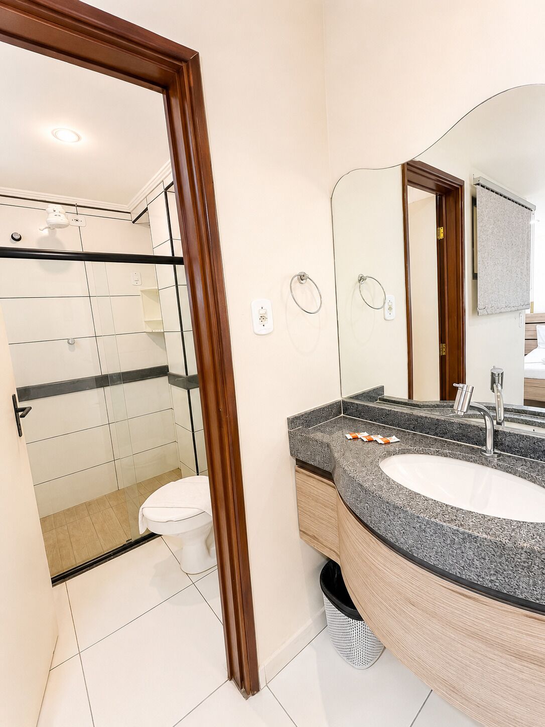 A modern bathroom with a shower, toilet, and sink.