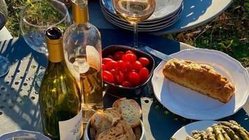 A picnic setup with various food items and drinks on a table.