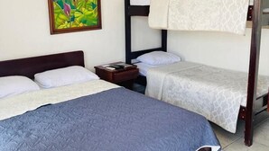 Ein Zimmer mit einem Etagenbett, einem Einzelbett und einem Nachttisch.