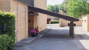 A building with a brick exterior, a sign labeled "CENTER", and a covered entrance. - Fredensborghusene Guesthouse (Fredensborg)