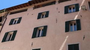 A multi-story building with a pink facade and green shutters on the windows. - B&B U Campanin (Dolceacqua)
