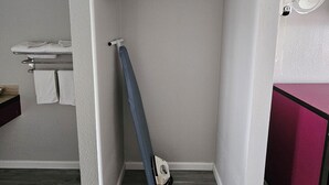 A compact bathroom with a shower, a towel rack, and a fan. - Travel Inn (Fortuna)