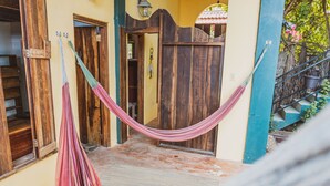 A wooden door with a hammock hanging in front. - Bella's Backpackers (San Ignacio)