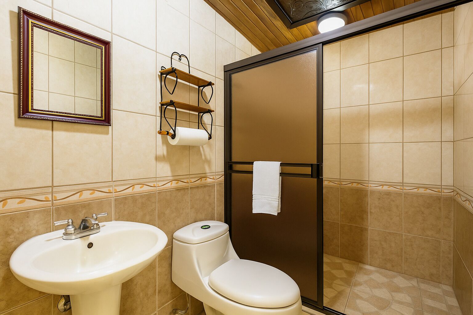 A bathroom with a sink, toilet, and a glass shower enclosure.