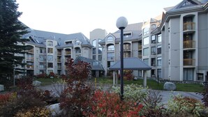 A multi-story residential building with balconies, a central courtyard, and a street lamp. - Marquise Condos by Whistler Retreats (Whistler)
