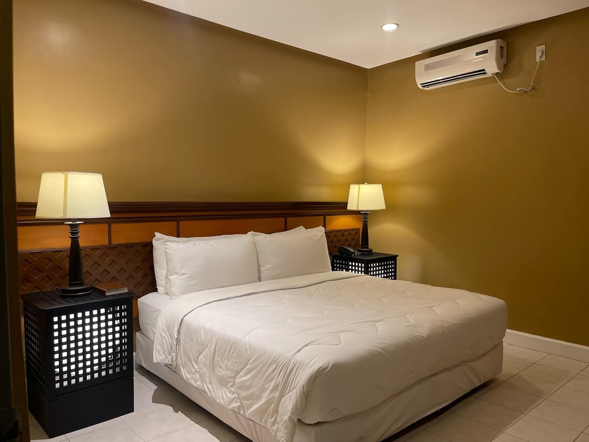 Minibar, tabla de planchar con plancha, ropa de cama