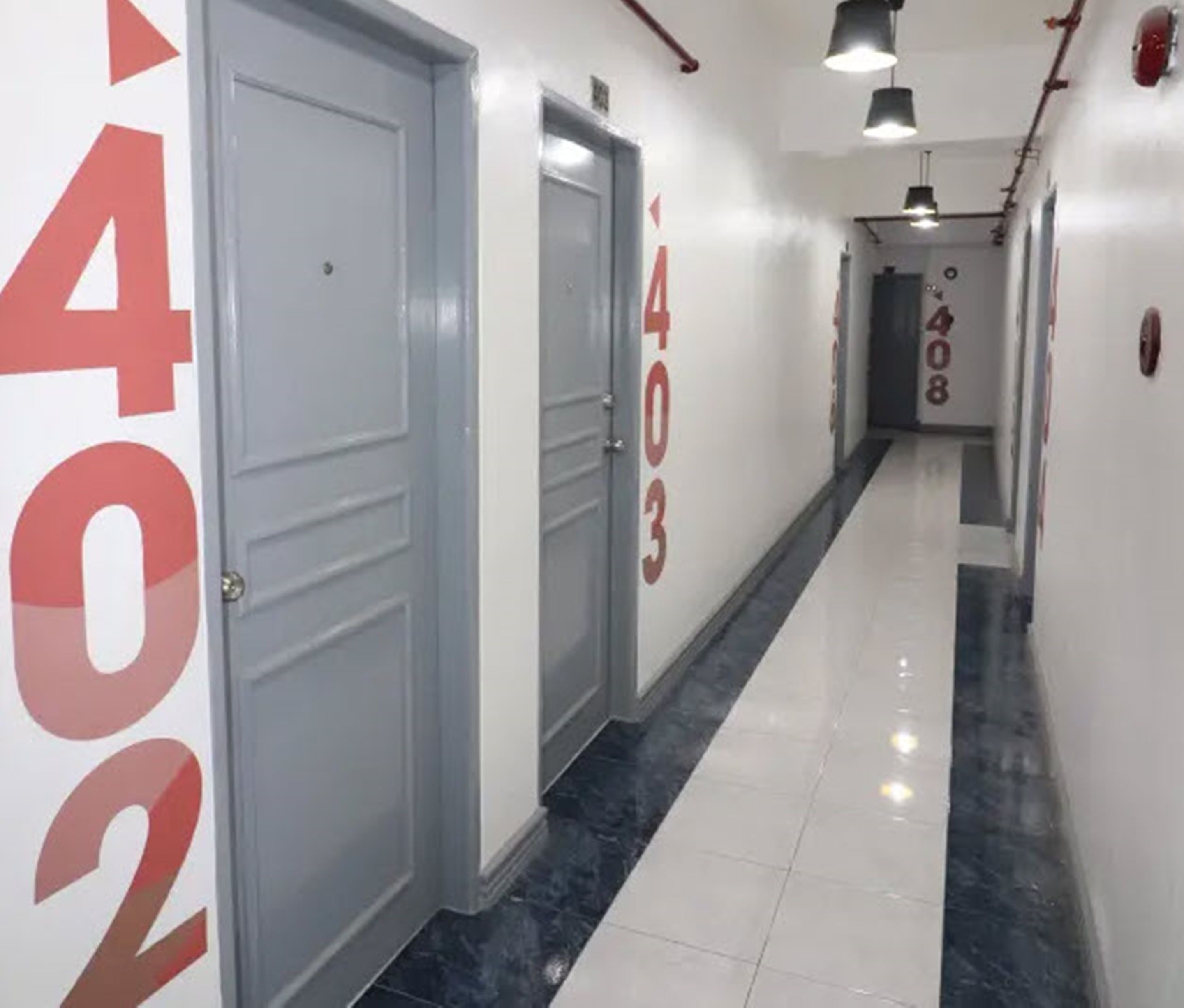 A hallway with doors numbered 402, 403, and 408.