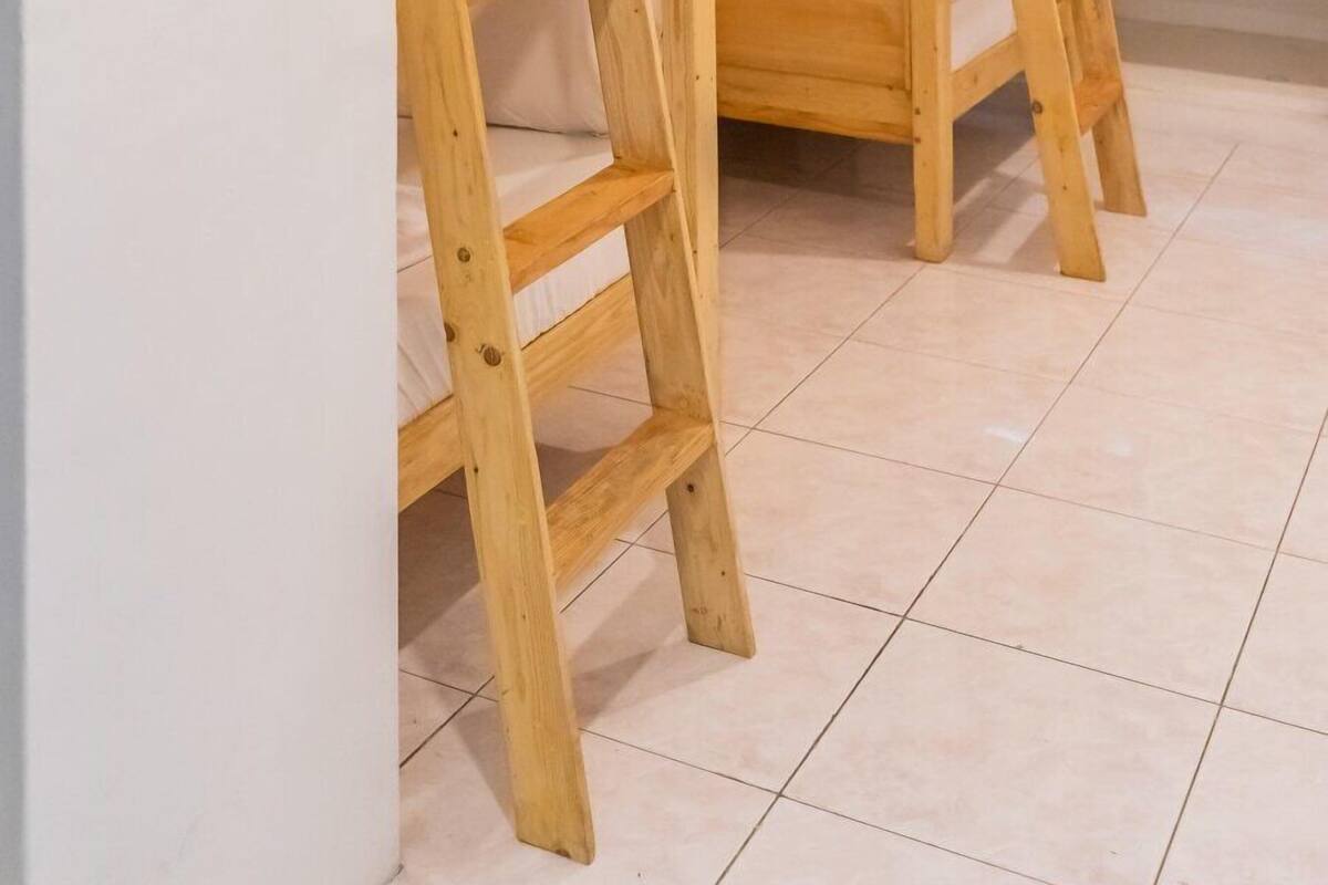 A room with bunk beds and a ladder.