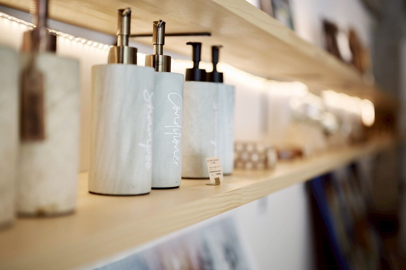 A shelf with various toiletries, including a bottle labeled "shampoo" and a bottle labeled "conditioner."