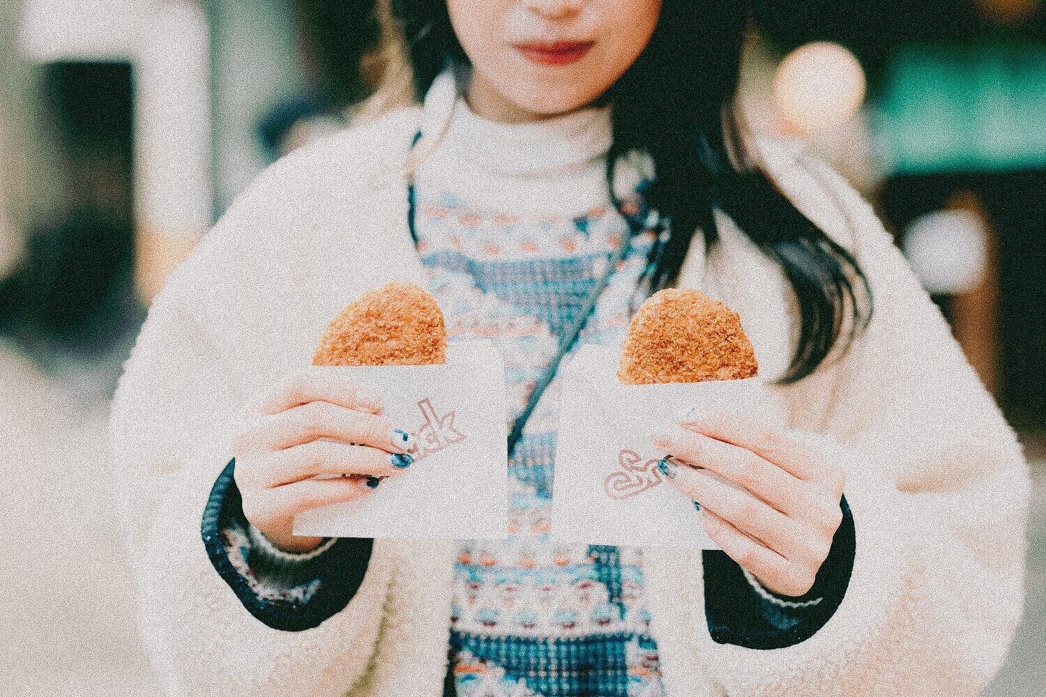 A person holding two triangular objects.