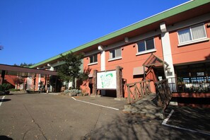 A building with a green roof and a large signboard. - Iwanai Kogen Hotel (Iwanai)