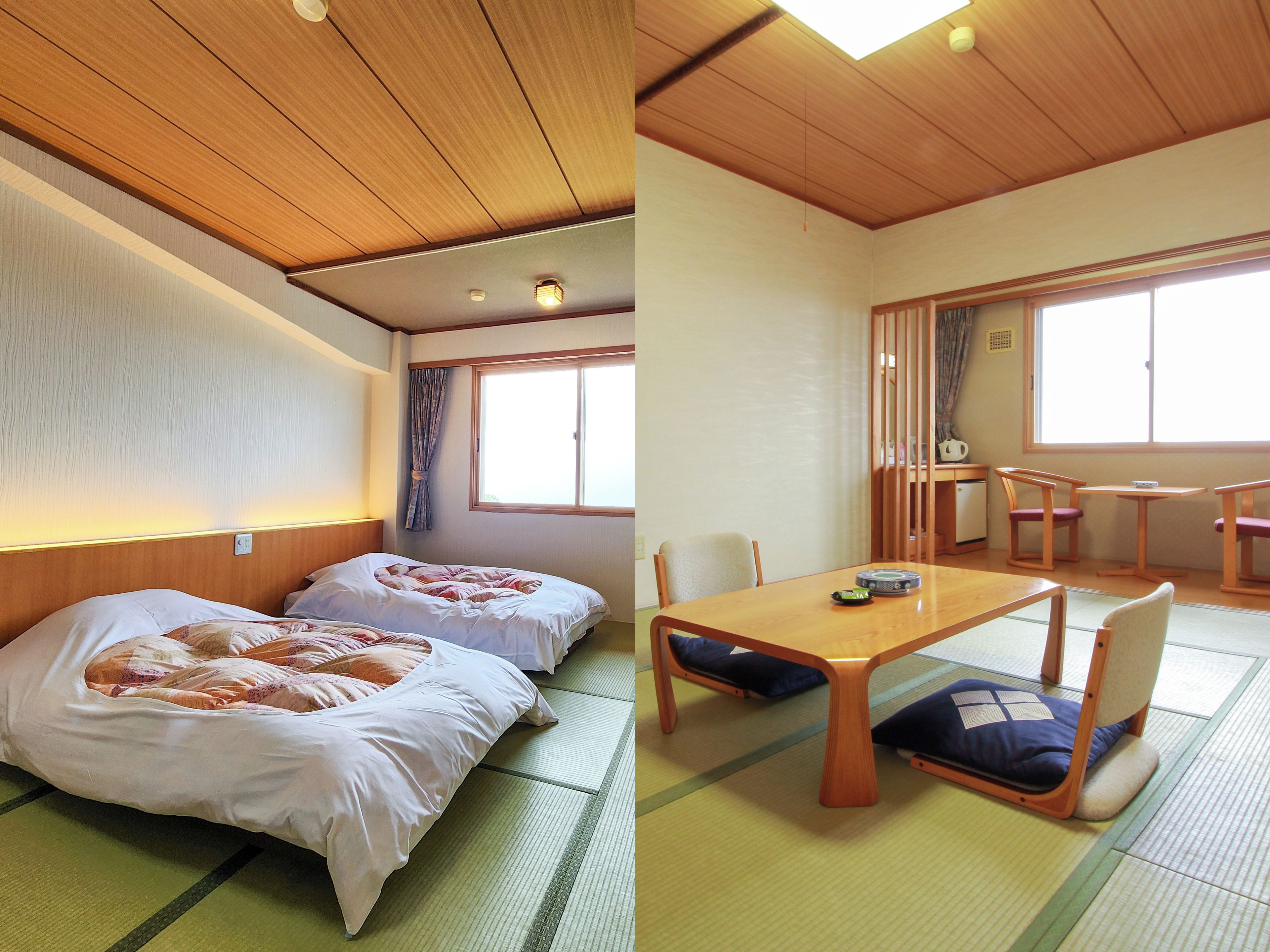 A room with two beds, a dining table, chairs, and a view of the outside through a window.