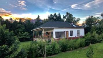 Situated in a serene natural setting, this single-story building offers a covered porch area perfect for relaxation.