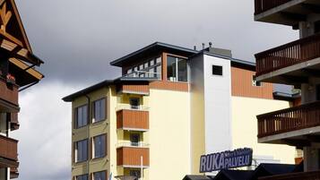 A multi-story building with a sign for 'Ruka Palvelu' and 'Safari House'.