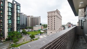 A high-rise building with multiple floors, large windows, and a mix of modern and classical architectural styles. - Yixiang Spring Travel (Jiaoxi)