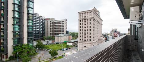 A high-rise building with multiple floors, large windows, and a mix of modern and classical architectural styles.