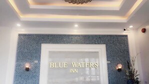 A reception area with a sign reading "BLUE WATERS INN" and a reception desk. - Blue Waters Inn Coron (Coron)