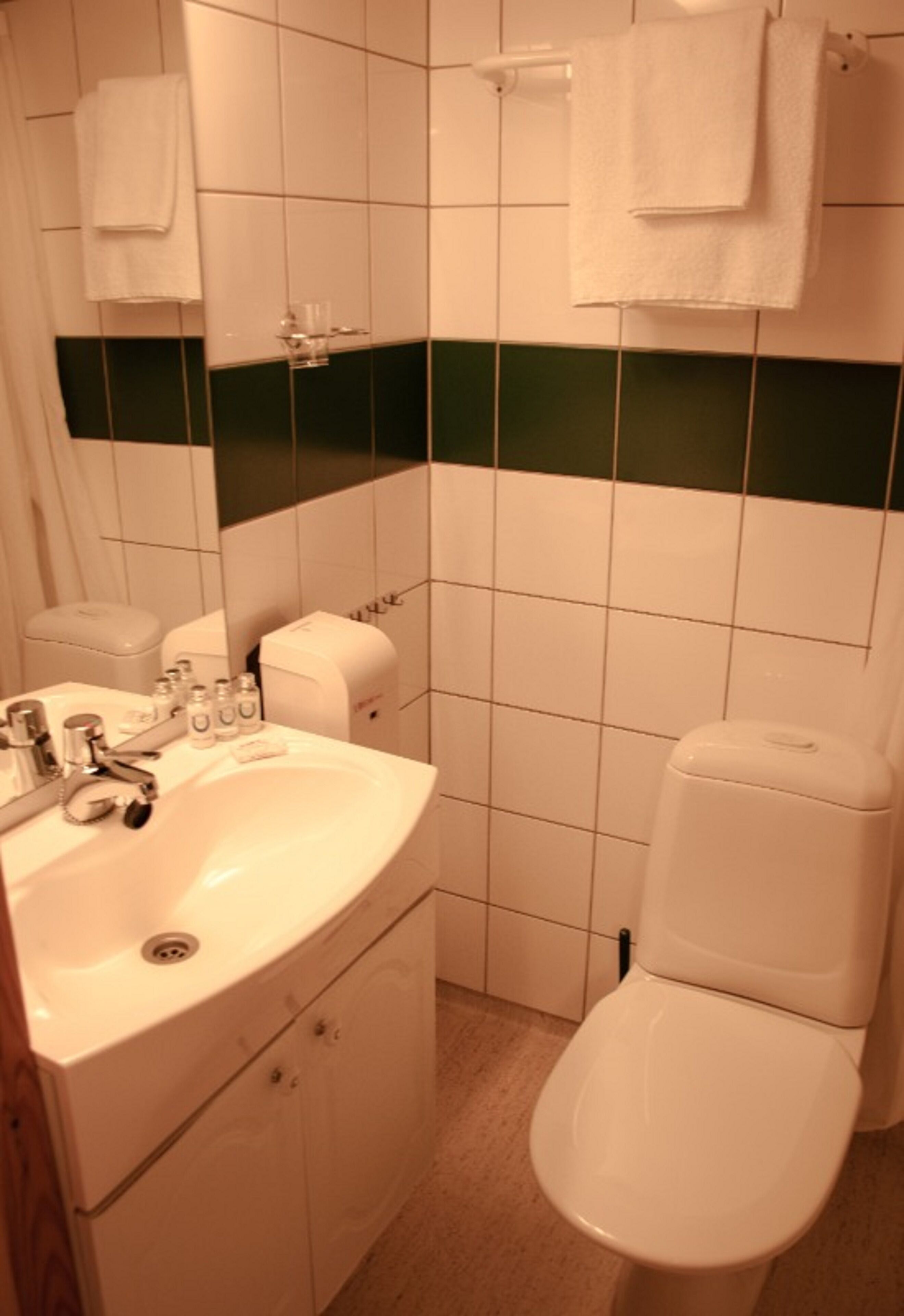 single room | bathroom | shower, hair dryer, soap, shampoo