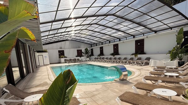 Seasonal outdoor pool, open 10:00 AM to 10:00 PM, pool umbrellas