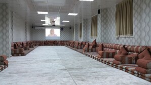 A conference room with a long table and patterned sofas. - Karaali Kpalicalari ve Otel Tesisleri (Sanliurfa)